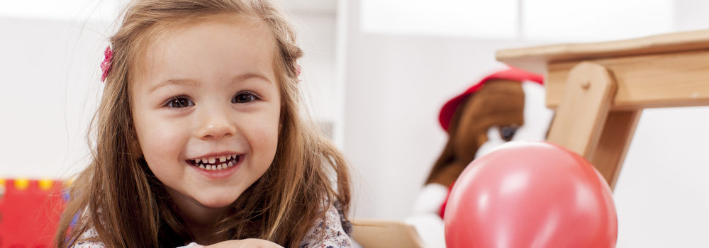 Happy little girl playing in room. Whole house humidifiers improve the health of your loved ones